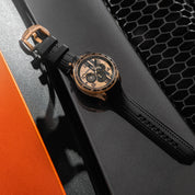Luxury watch with black leather strap on a car grille