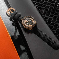 Luxury watch with black leather strap on a car grille