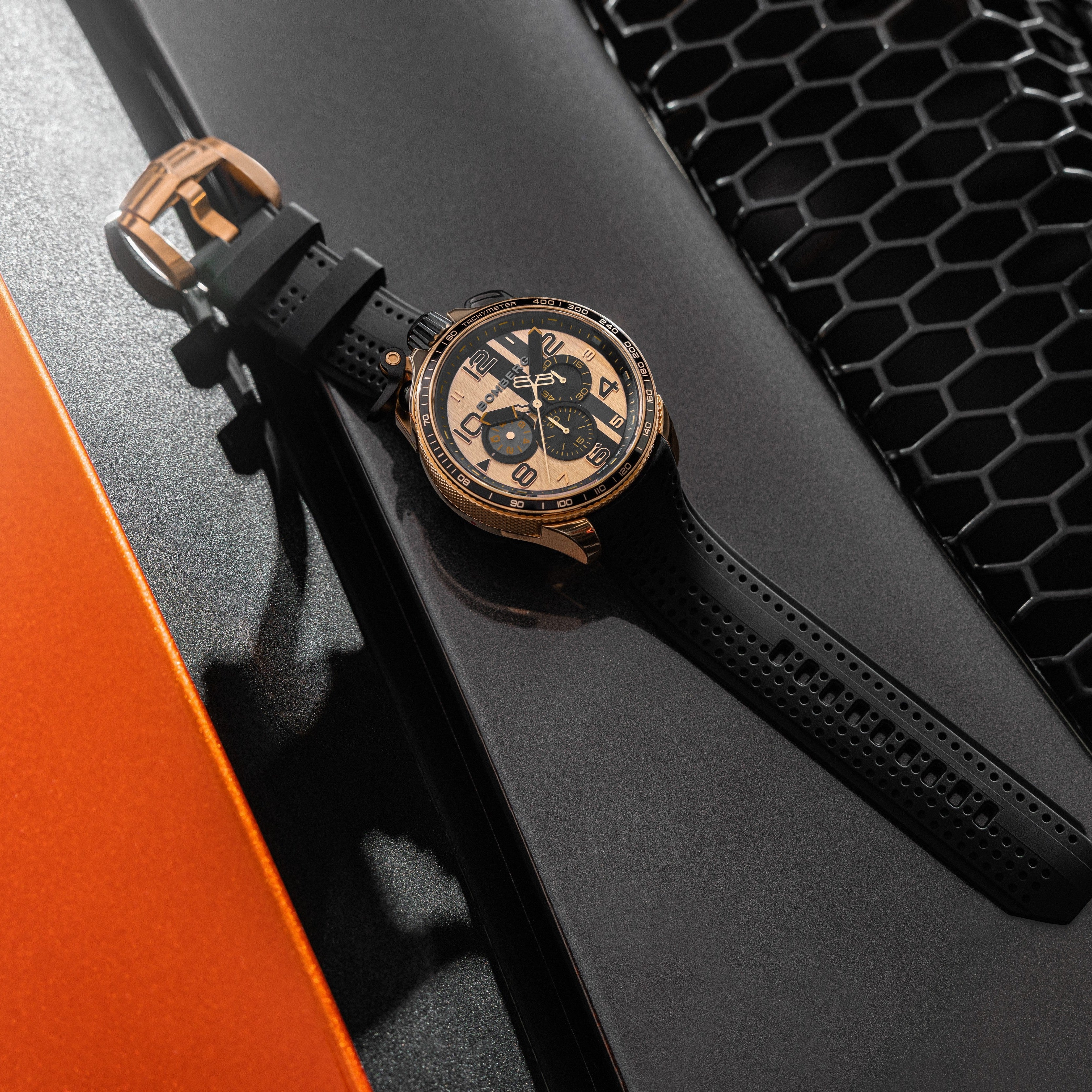 Luxury watch with black leather strap on a car grille